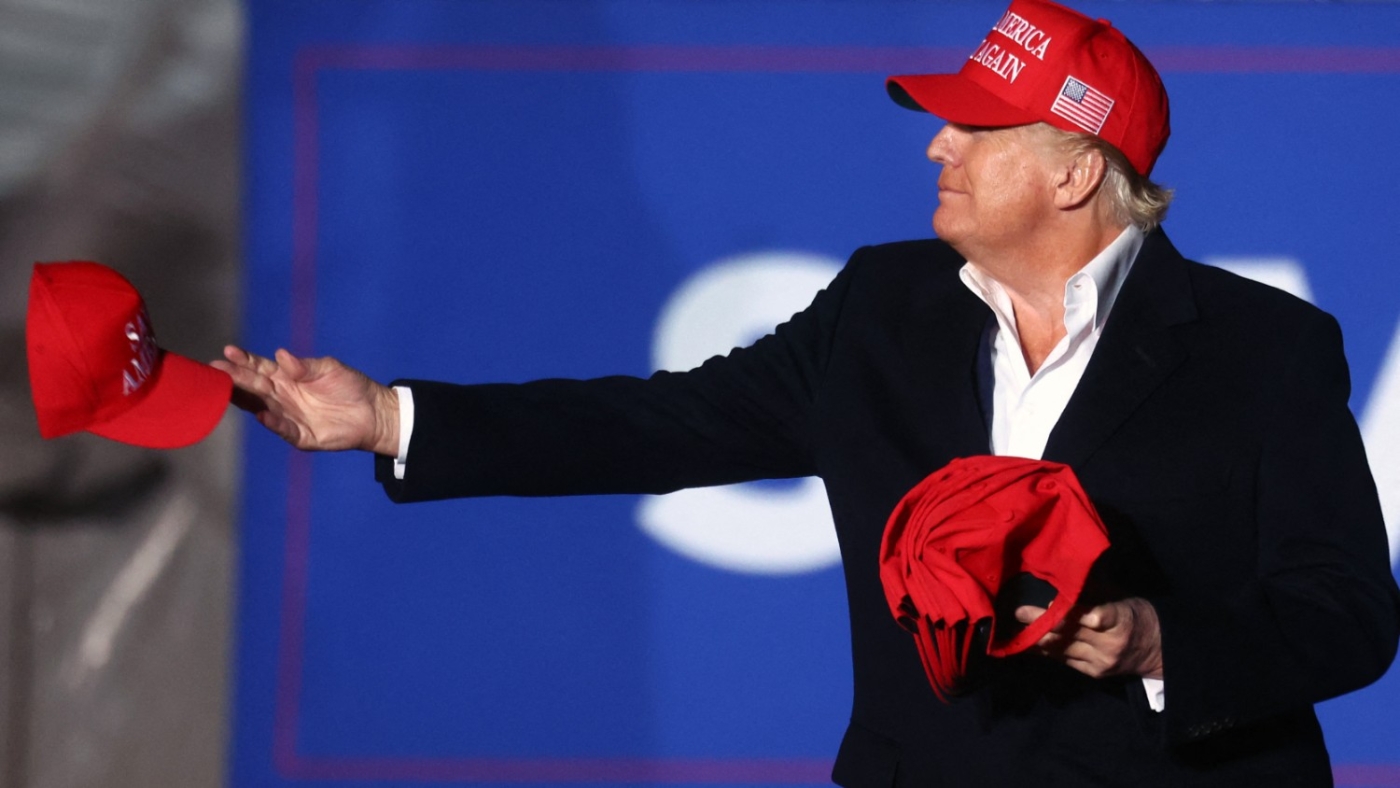 Former President Donald Trump tosses a MAGA hat to the crowd before speaking at a rally in Florence, Arizona on 15 January 2022.