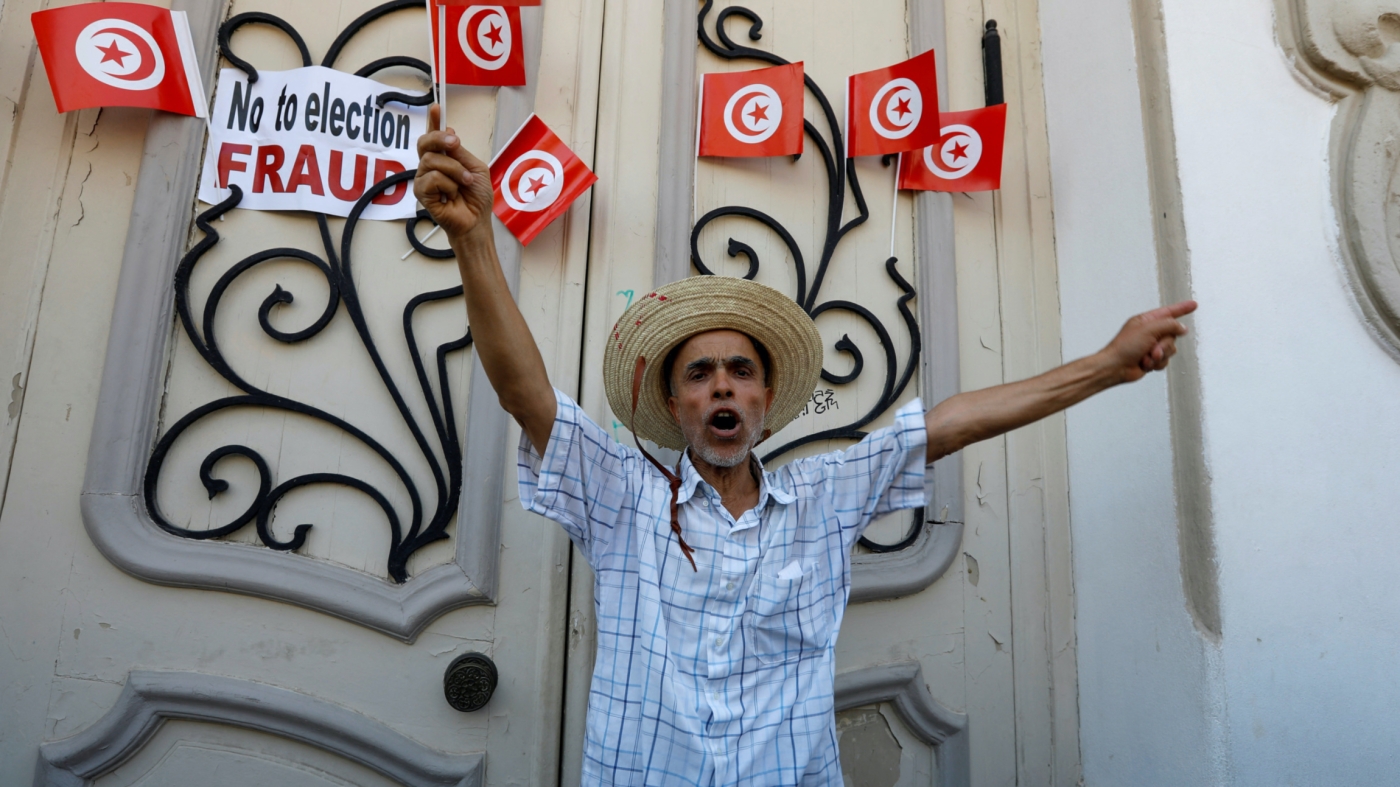 A demonstrator takes part in a protest against President Kais Saied's referendum on a new constitution, in Tunis, on 23 July 2022 (Reuters)