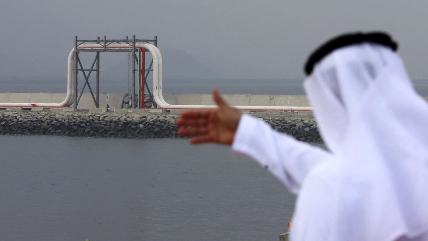 An Emirati man stands in front of a pipeline at the oil terminal of Fujairah during the inauguration ceremony of a dock for supertankers on 21 September 2016.