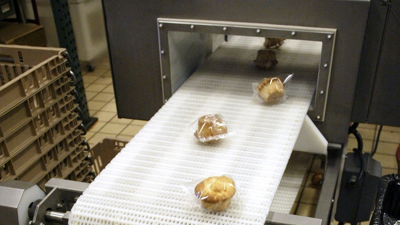 Muffins are run through a metal detector, before leaving a prison's food factory in the state of Washington.