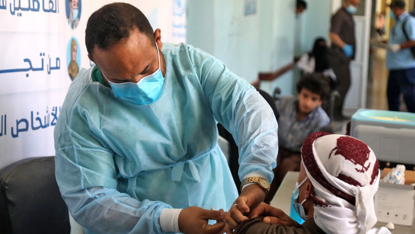 A Yemeni health worker receives a dose of the AstraZeneca Covid-19 vaccine at a vaccination centre in Yemen's city of Taez, on 21 April 2021.
