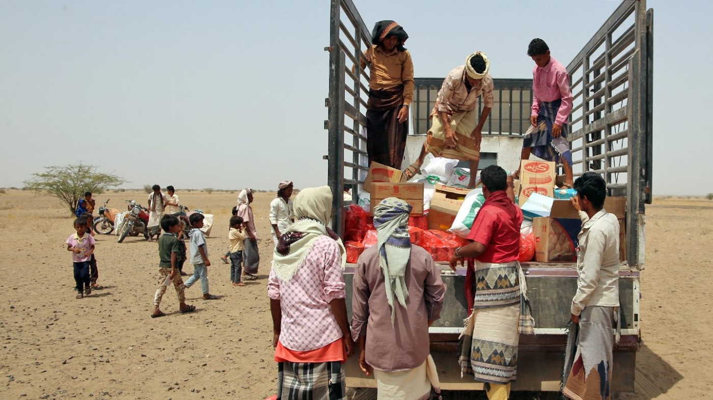 Yemenis displaced by the conflict, receive food aid and supplies to meet their basic needs, at a camp in Hays district in the war-ravaged western province of Hodeida on 29 March 2022.