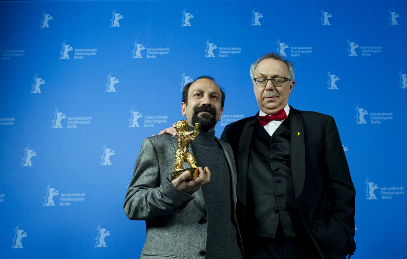 Asghar Farhadi, left, in 2011 with the Golden Bear he won in 2011 for A Separation: to his right is festival chief Dieter Kosslick (AFP)