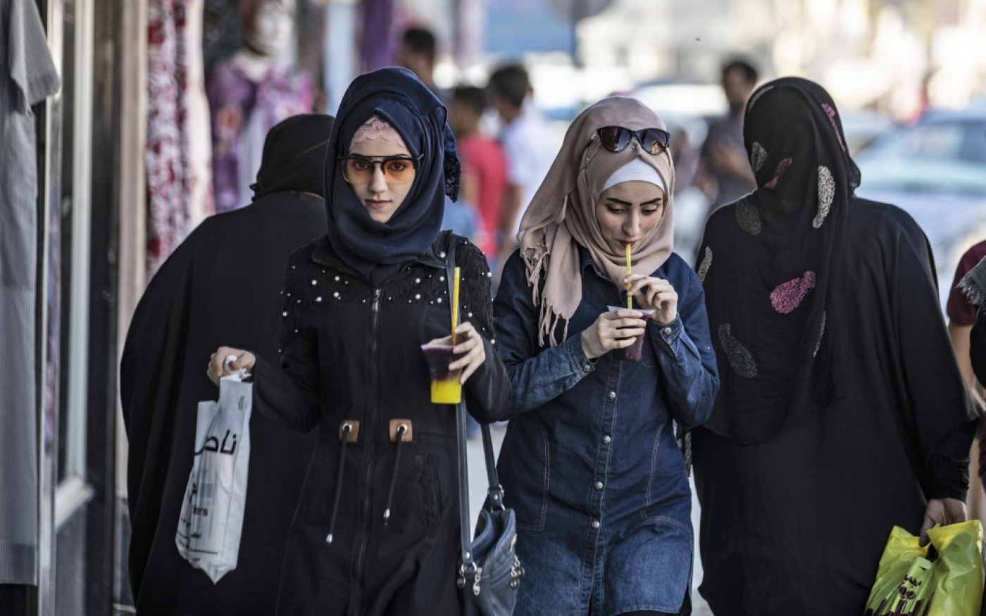 Des jeunes filles marchent dans Raqqa, ex-capitale du groupe État islamique, le 21 août 2019 (AFP)