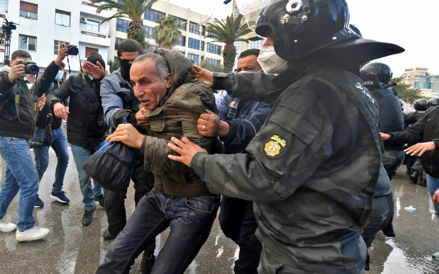 Un Tunisien est arrêté à la suite d’affrontements avec la police lors de manifestations contre le président Kais Saied, à l’occasion du onzième anniversaire de la révolution tunisienne, le 14 janvier 2022 (Fethi Belaid)