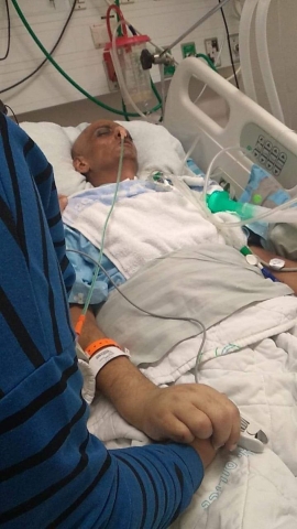 Hussein Masalmeh lies critically ill in a hospital bed (Twitter)
