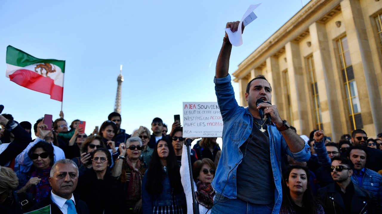 A demonstrator addresses a crowd in Paris during a rally in support of Iranian protests on 9 October 2022 (AFP)
