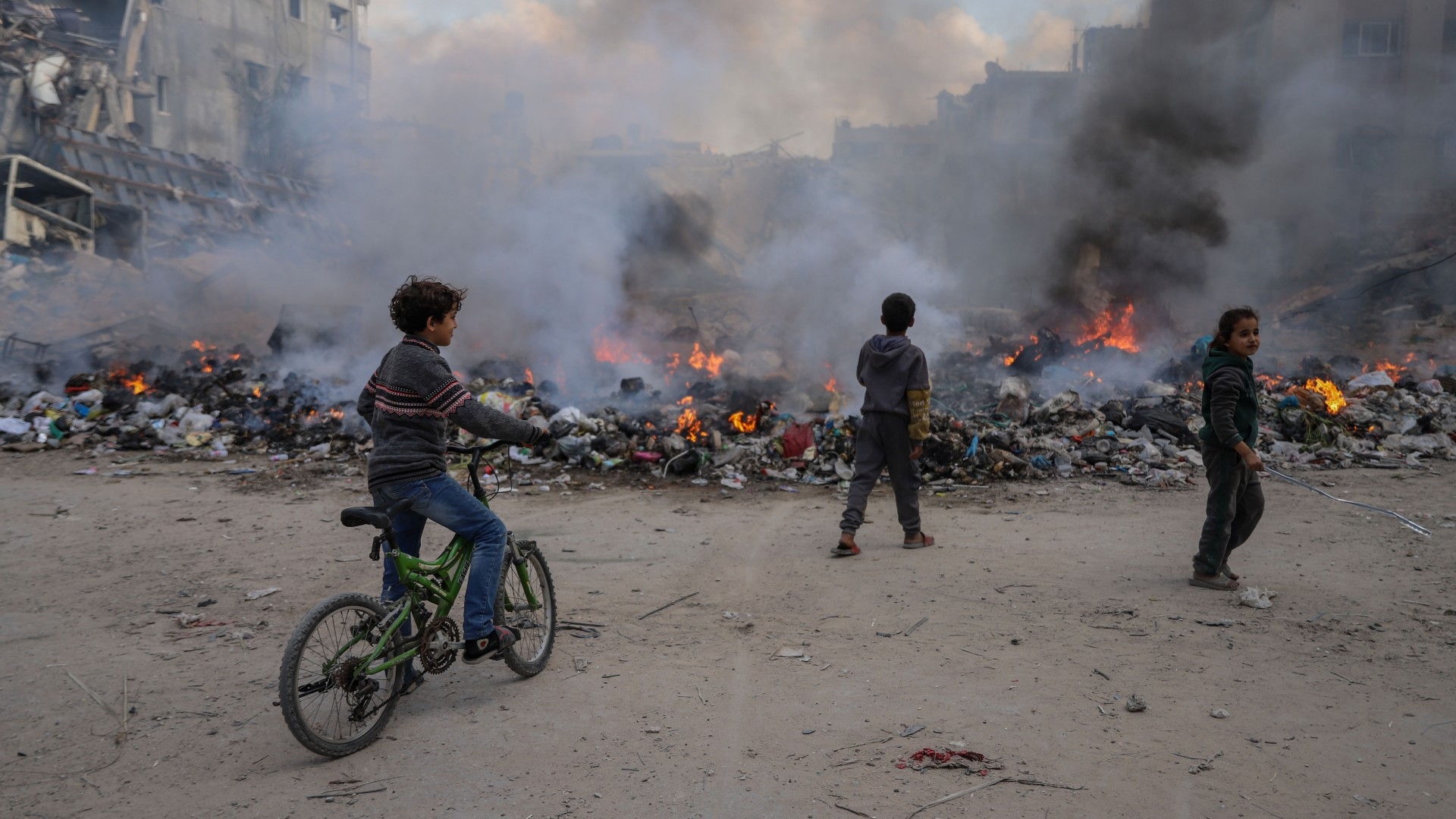 Gaza has been threatened by plague and deadly diseases as garbage fills the streets. In this photo a group of children play near a waste landfill site in Gaza City (MEE/Mohammed al-Hajjar)
