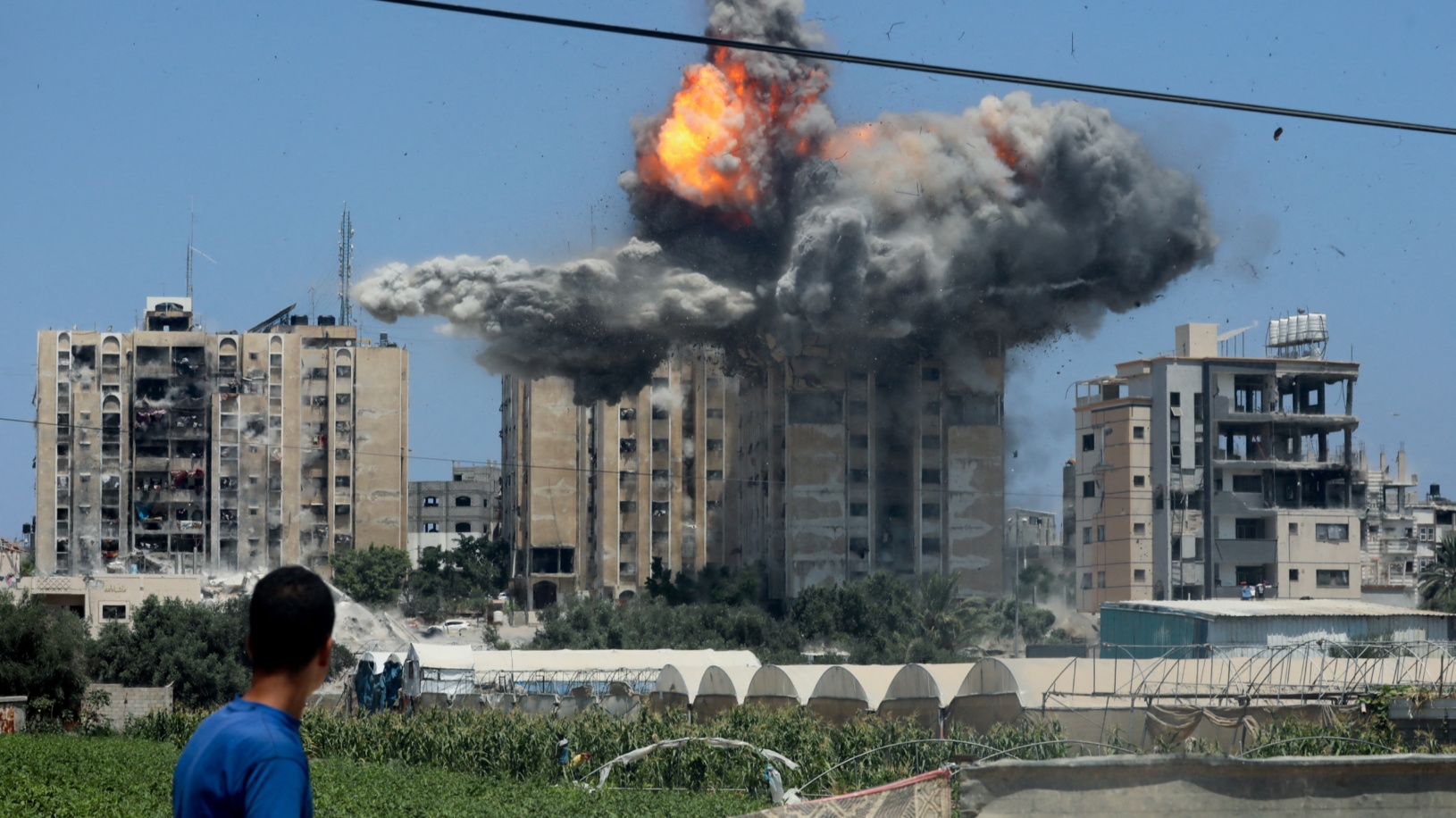 An explosion occurs following an Israeli strike on a residential building in Nuseirat, central Gaza on 20 July 2024 (Omar Naaman/Reuters)