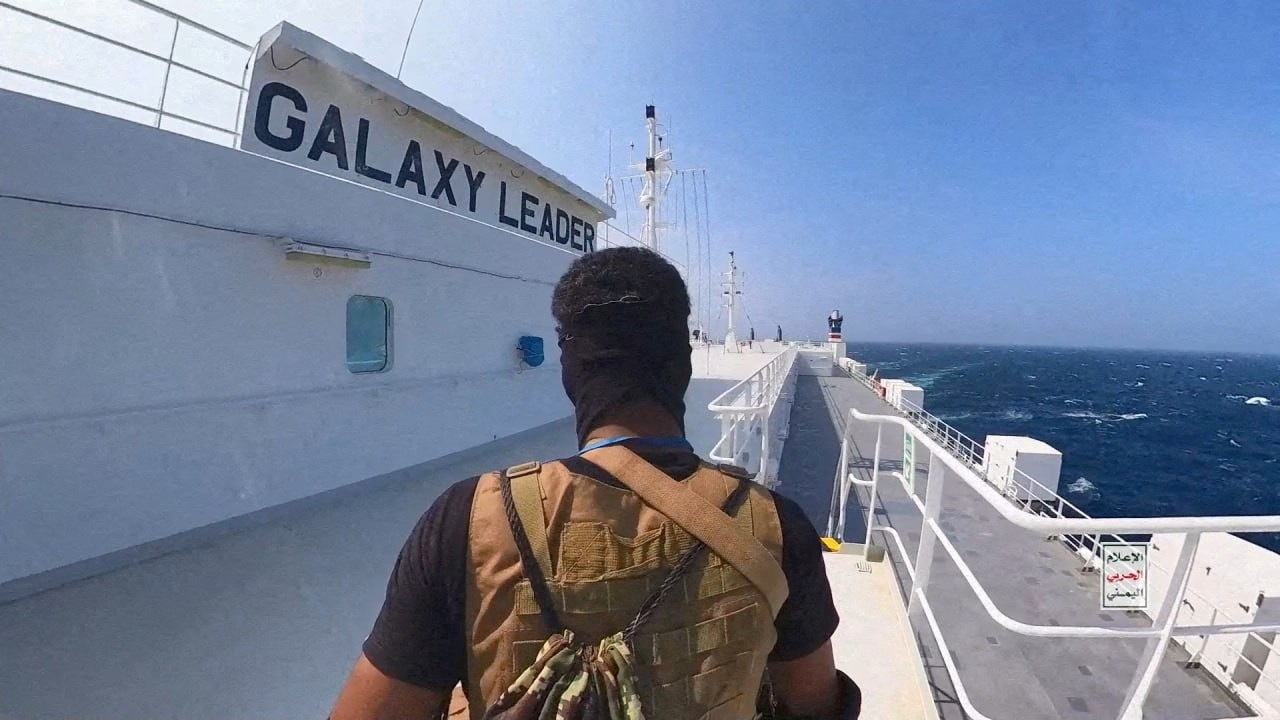 A Houthi fighter stands on the Galaxy Leader cargo ship in the Red Sea in this photo released on 20 November 2023 (Houthi Military Media/Handout via Reuters)