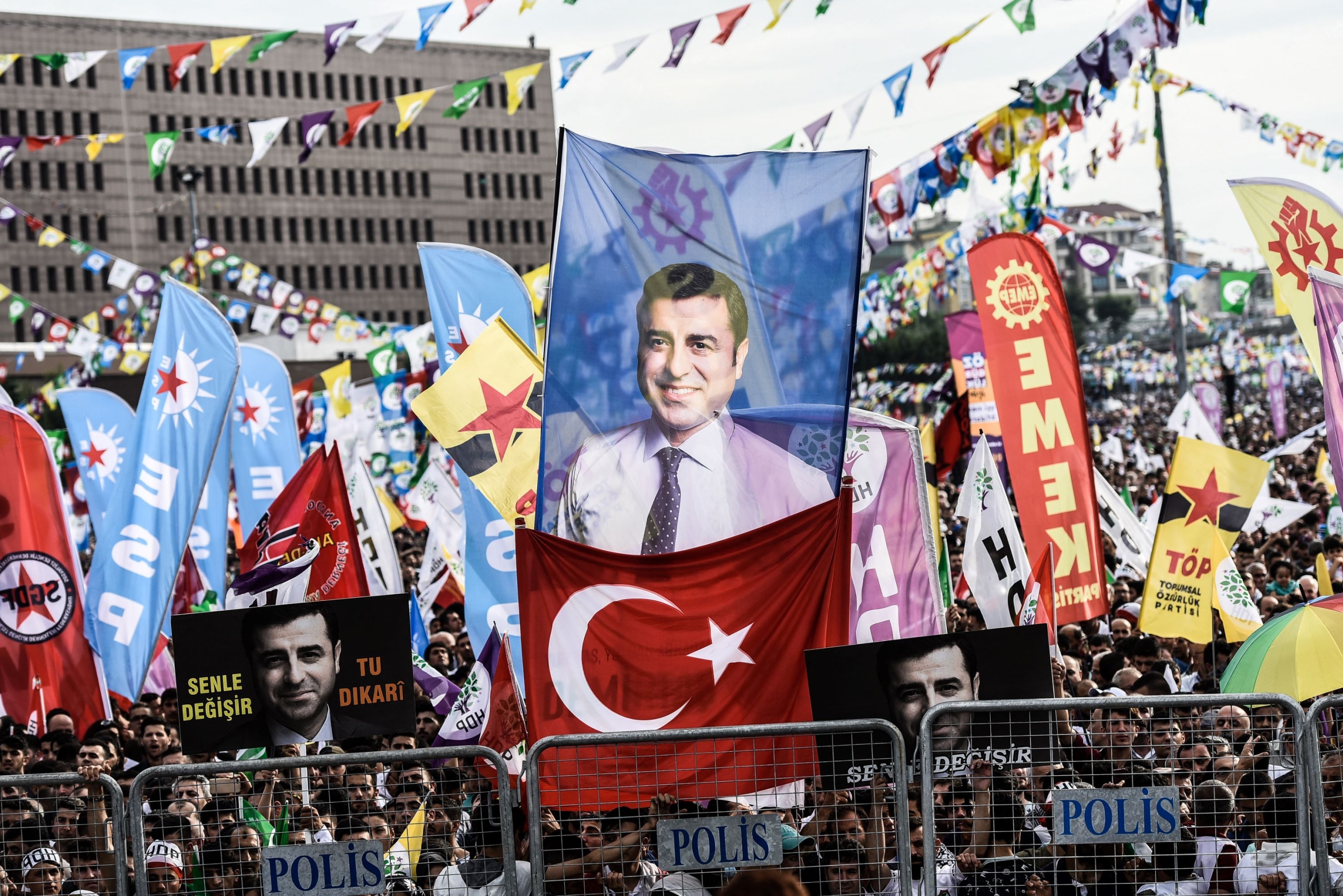 Supporters of imprisoned Selahattin Demirtas, presidential candidate of the HDP, hold HDP and other left-wing flags with picture of Demirtas during an election campaign in Istanbul on June 17, 2018 (AFP)