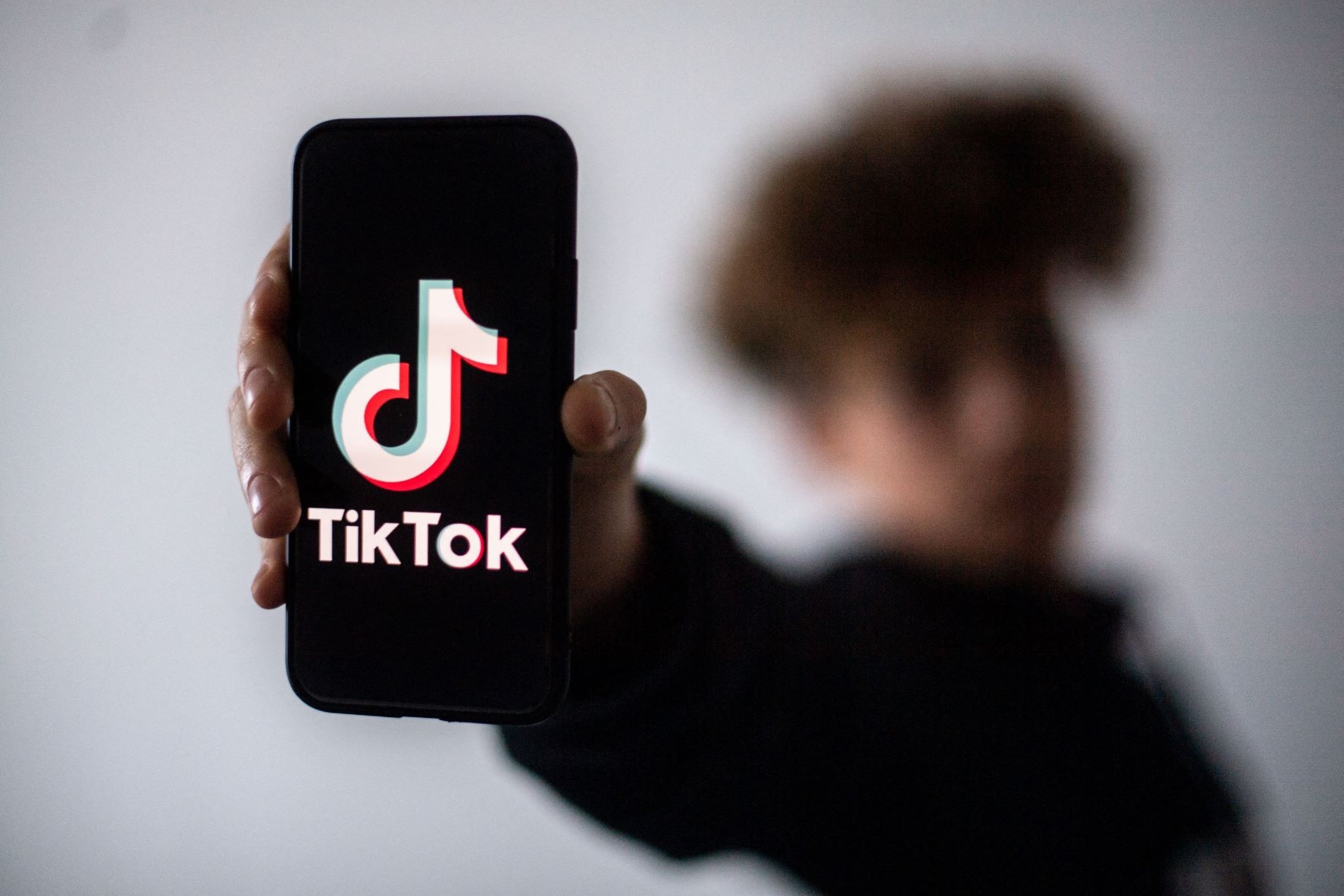 In this file photo taken on January 21, 2021 a teenager presents a smartphone with the logo of Chinese social network Tik Tok in Nantes, western France (AFP)