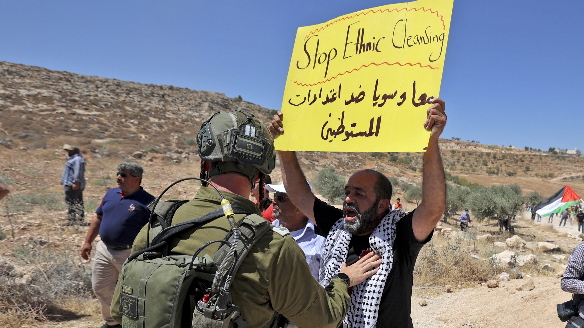 Israeli forces contain Palestinian protesters during a demonstration against settlement expansion, in the village of al-Mughayyir, east of Ramallah in the occupied West Bank, on July 29, 2022 (Abbas Momani/AFP)