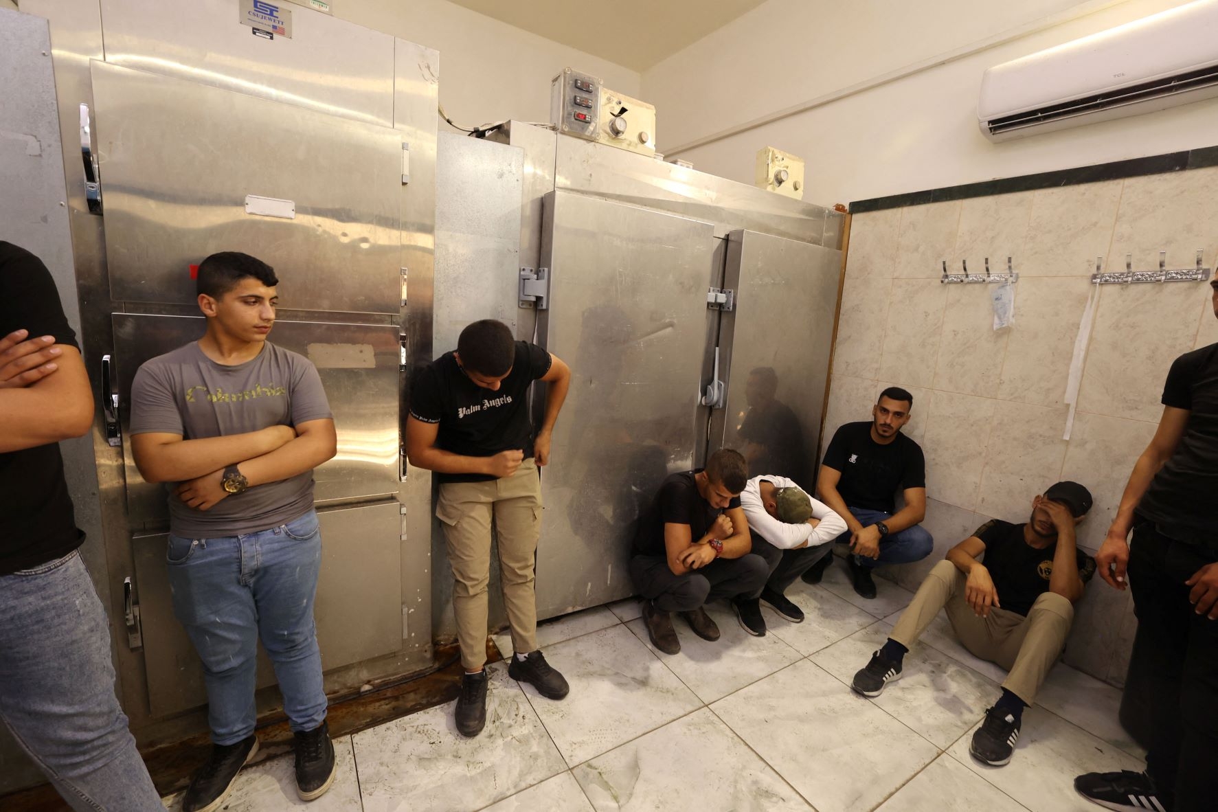 Friends and relatives mourn the death of Palestinian Uday Salah, 17, killed by Israeli forces, at the Jenin hospital morgue, in the occupied West Bank, on 15 September 2022 (AFP)