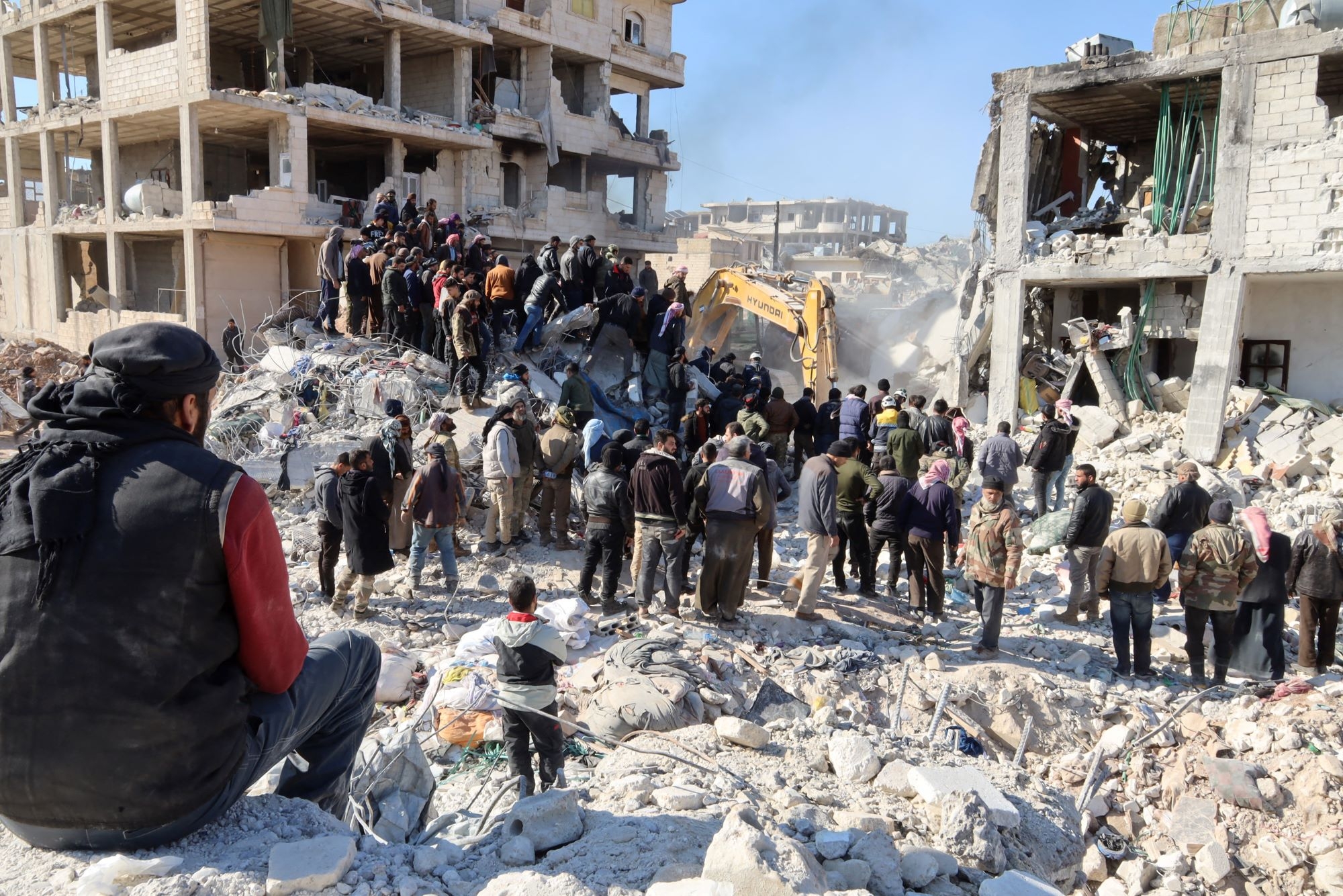 Rescue workers look for survivors amid the rubble of a building in the rebel-held town of Jindayris on February 9, 2023, three days after a deadly earthquake that hit Turkey and Syria (AFP)