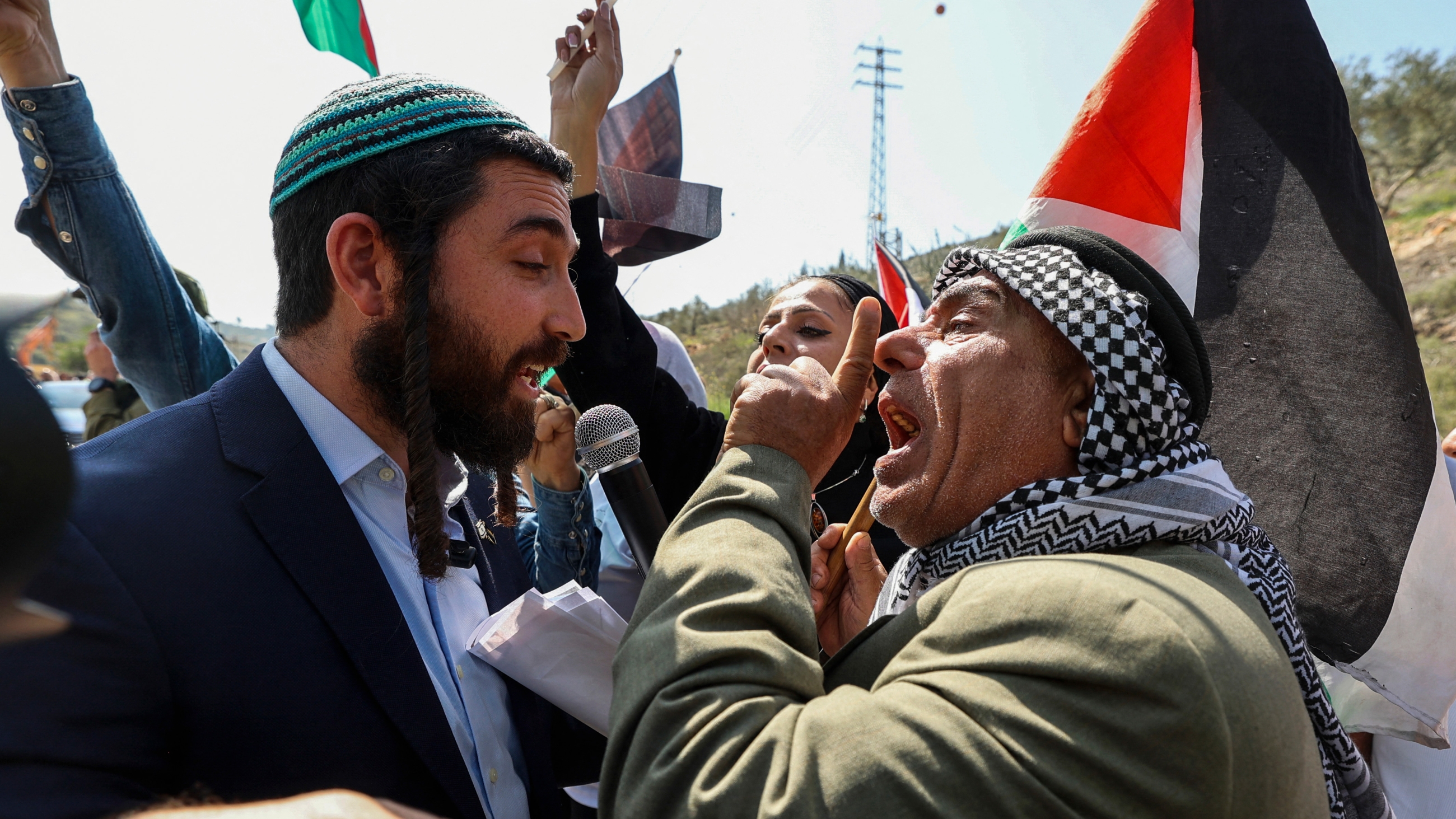 Israeli MP Tzvi Sukkot (L) is confronted as he tries to interrupt a rally by Palestinians against settler violence in the occupied West Bank town of Huwwara on 3 March 2023 (AFP)