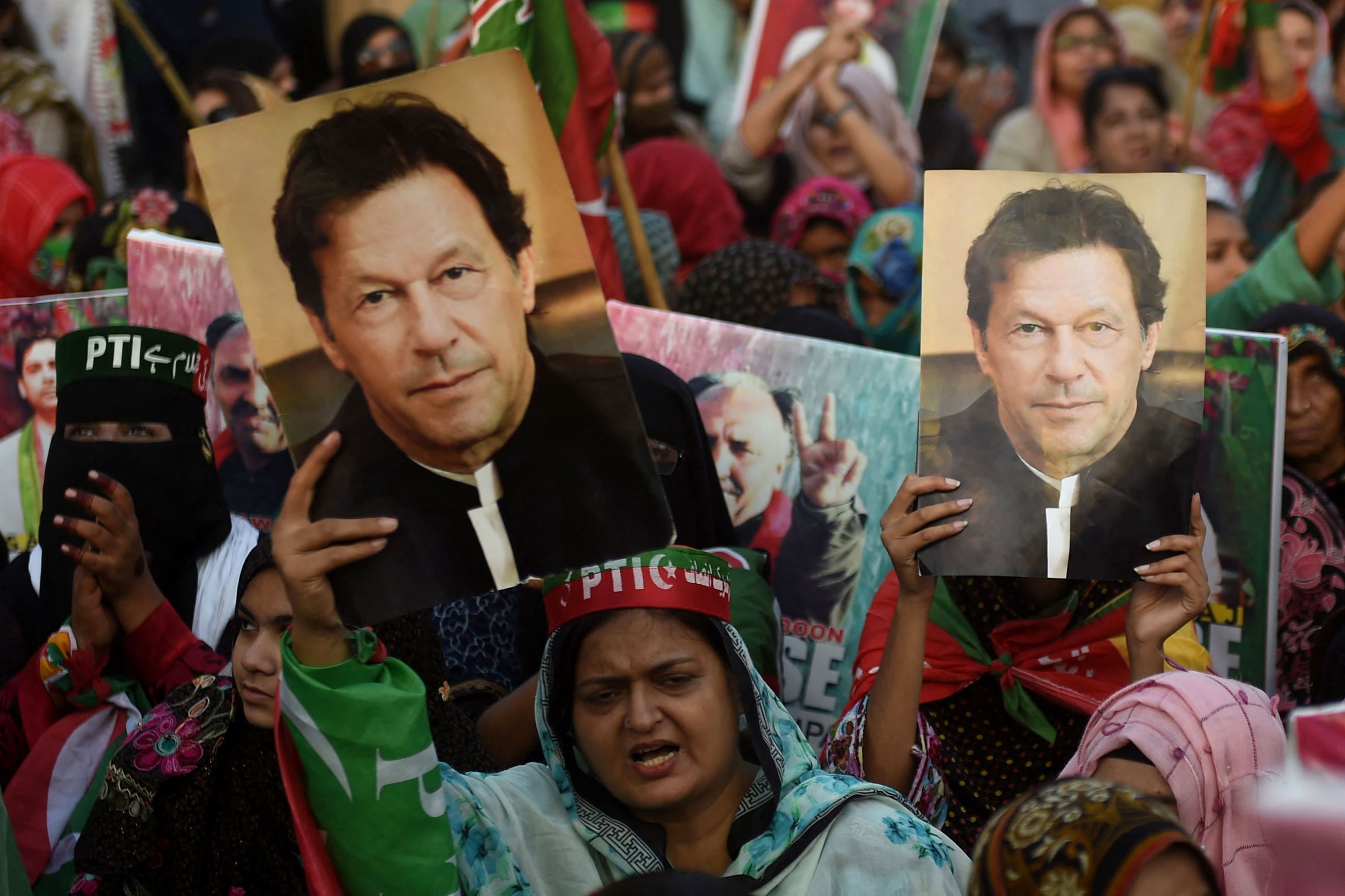 Supporters of Pakistan's former prime minister Imran Khan, carry placards displaying a portrait of Khan during a protest in Karachi on March 19, 2023, demanding release of arrested party workers in recent police clashes (AFP)