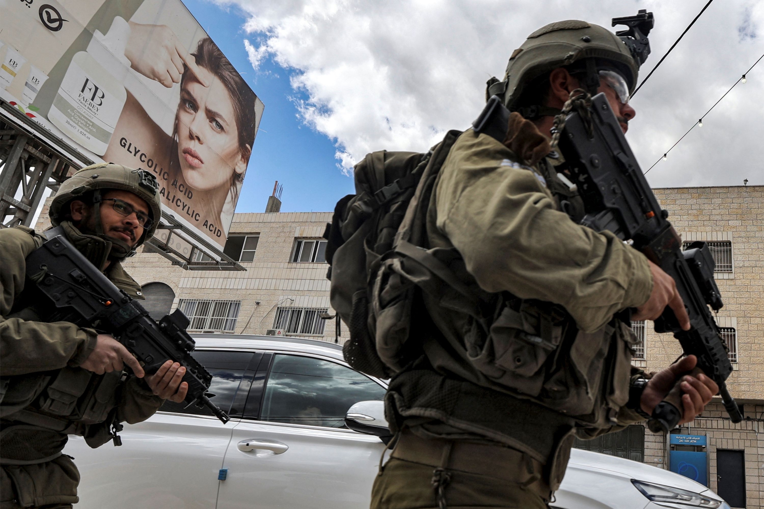 Israeli soldiers stand before Palestinian protesters (not pictured) gathering for a Land Day demonstration in the Palestinian town of Huwara in the occupied West Bank on March 31, 2023 (AFP)