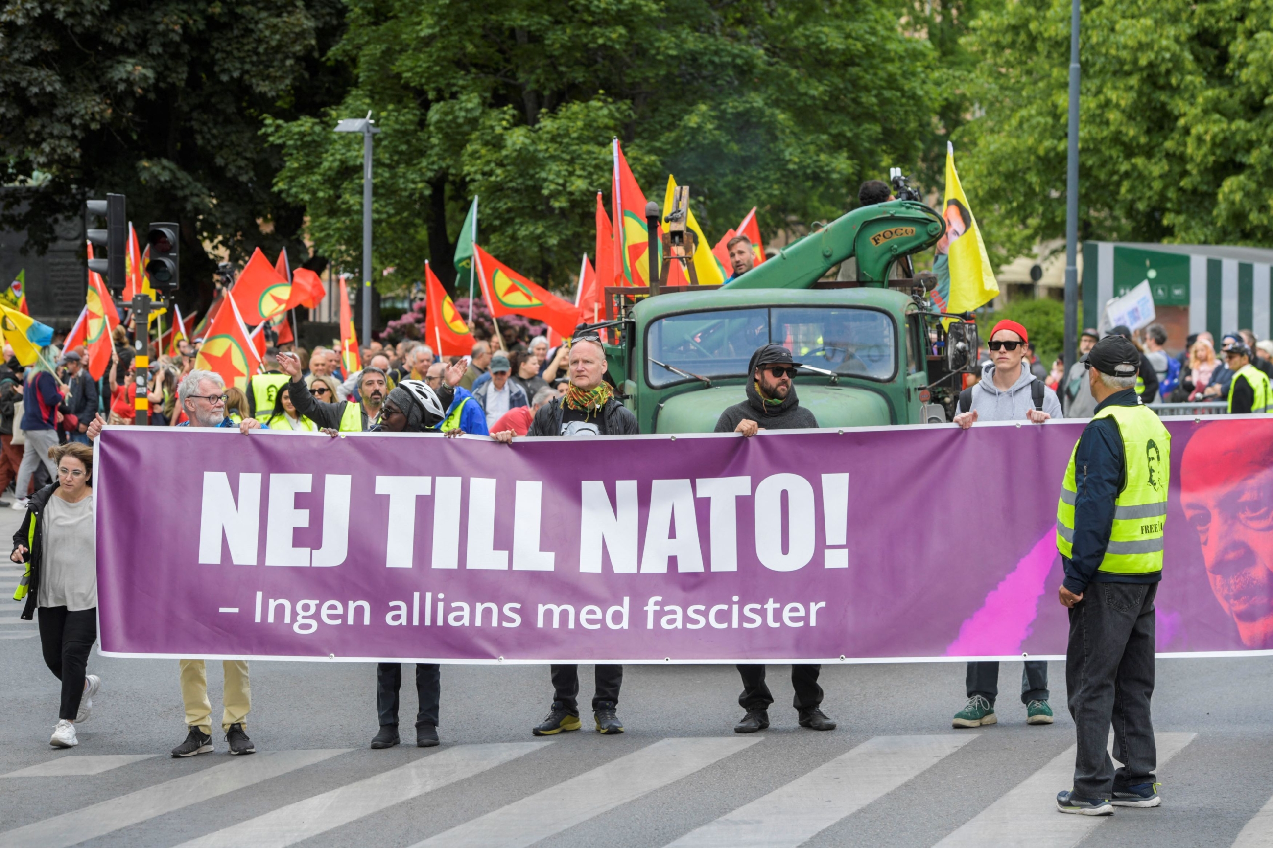 Activists of the "Alliance against NATO" network hold a banner reading "No to NATO! - No alliance with fascists" during a demonstration in Stockholm on 3 June (AFP)