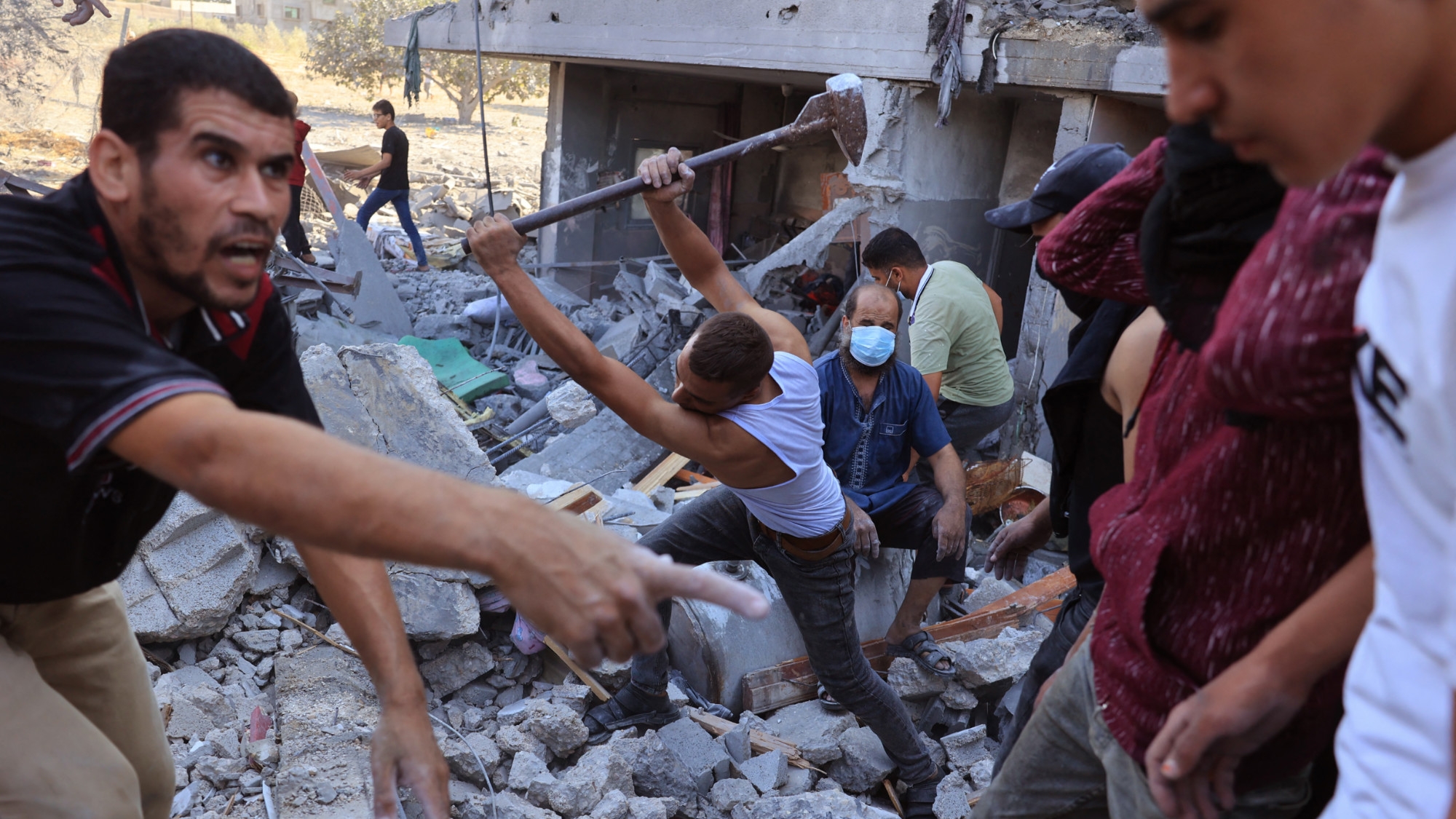 Palestinians dig in the rubble of a collapsed building searching for people following an Israeli airstrike in Rafah, in the southern of Gaza Strip, on 16 October 2023 (AFP)