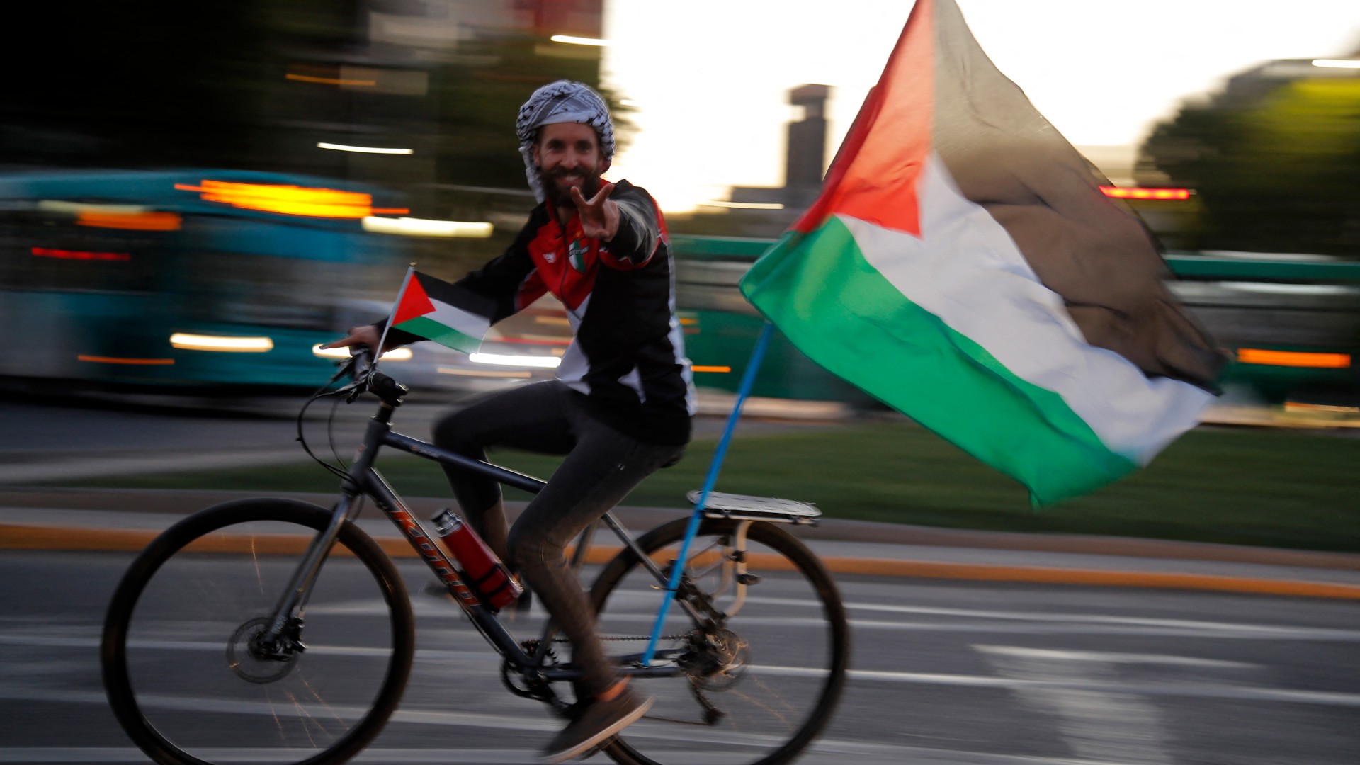 Members of the Palestinian community in Chile participate in a car caravan on the International Day of Solidarity with the Palestinian People at Plaza Italia square in Santiago on 29 November 2023 (Javier Torres/AFP)  