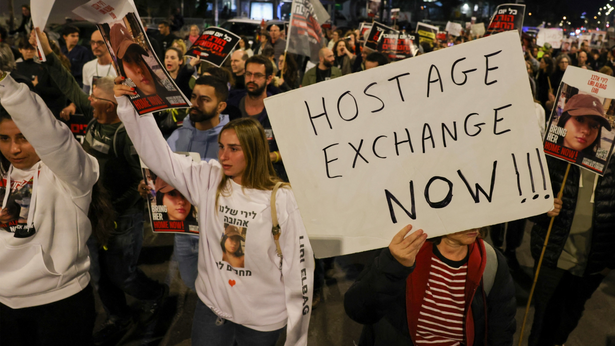 Families and supporters of captives held in Gaza hold a demonstration outside the Israeli ministry of defence in Tel Aviv on 15 December 2023 (AFP)