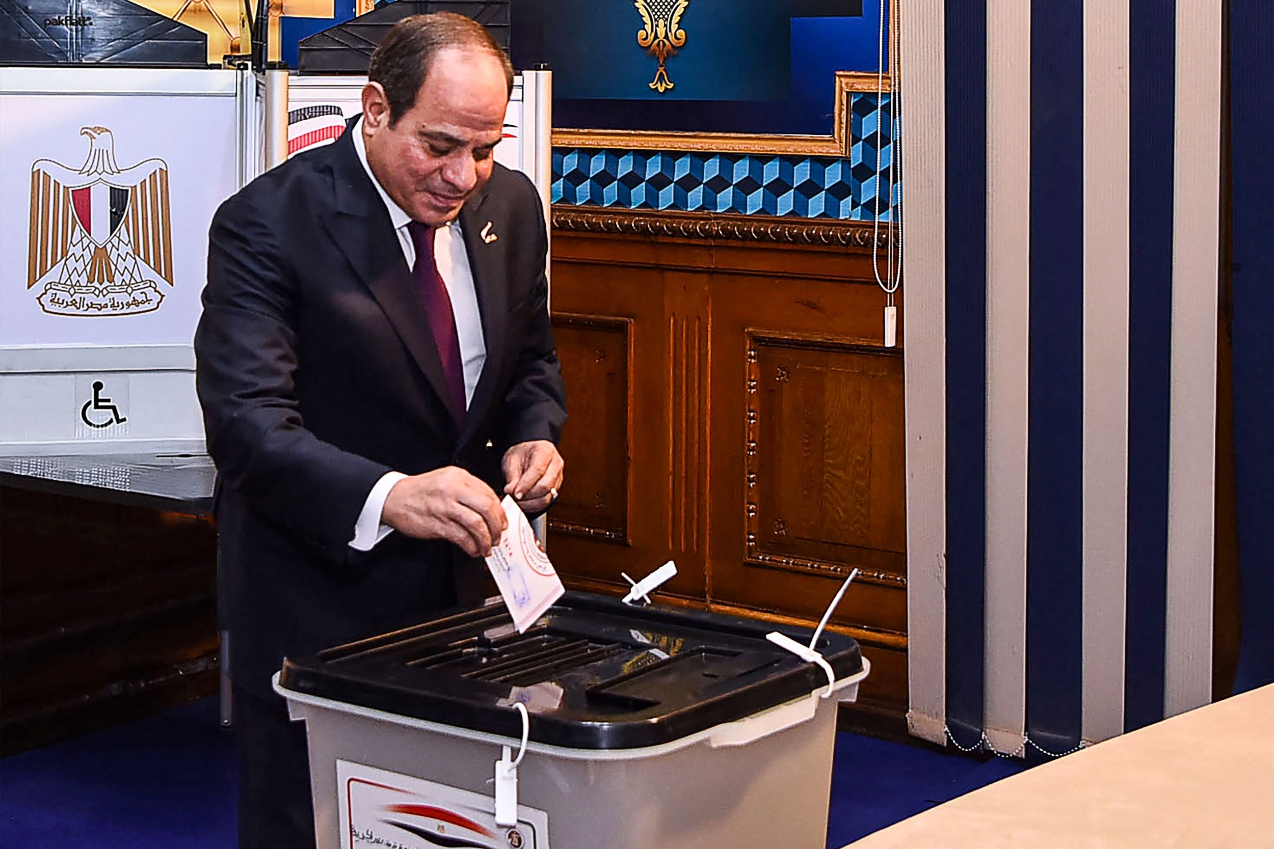 This handout picture released by the Egyptian Presidency on December 10, 2023, shows Egyptian president Abdel Fattah al-Sisi casting his vote in the presidential election at Mustafa Yousry Emmera School in Cairo (Egyptian Presidency/AFP)