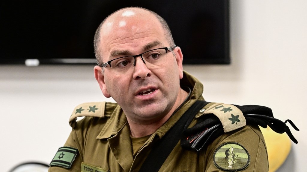 Colonel Moshe Tetro holds a press conference at the Kerem Shalom border crossing with the southern Gaza Strip on December 22, 2023 (AFP)