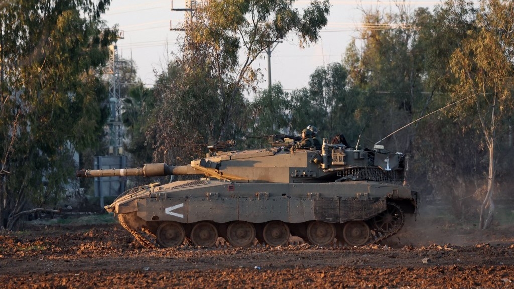 An Israeli army tank rolls in southern Israel along the border with the Gaza Strip amid continuing battles between Israel and Hamas (AFP)