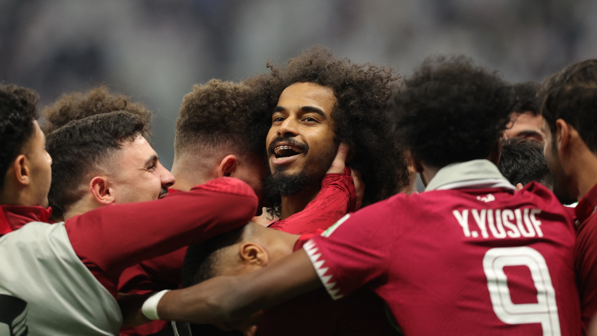 Qatar's forward Akram Afif celebrates with teammates after scoring his second goal during the AFC Qatar 2023 Asian Cup final football match between Jordan and Qatar at the Lusail Stadium in Lusail, north of Doha on 10 February 2024 (Giuseppe Cacace/AFP)