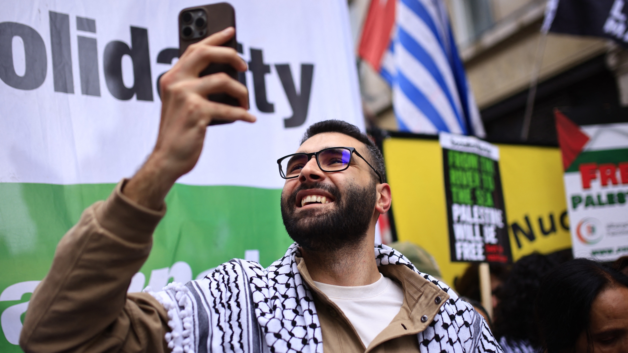 Palestinian photojournalist Motaz Azaiza joins pro-Palestinian supporters preparing to march through central London, on 18 May (AFP)