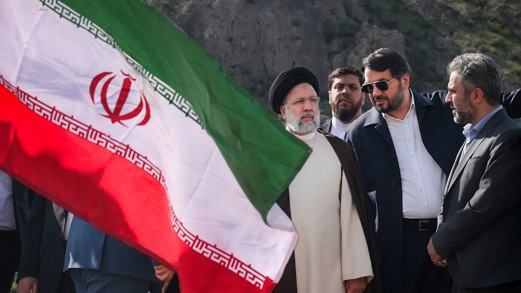 A handout picture provided by the Iranian presidency shows Iran's President Ebrahim Raisi (C) at the site of Qiz Qalasi, the third dam jointly built by Iran and Azerbaijan on the Aras River, ahead of its inauguration ceremony on 19 May 2024 (AFP)