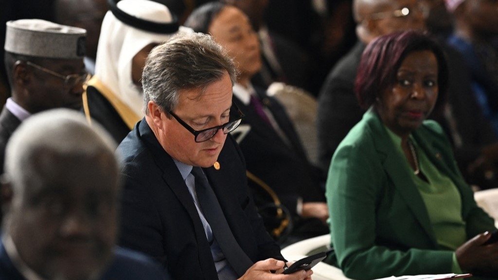 Former Foreign Secretary David Cameron looks at his mobile phone as he attends the Global Forum for Vaccine Sovereignty and Innovation at the French Foreign Ministry, the Quai d'Orsay, in Paris, on June 20 (AFP)