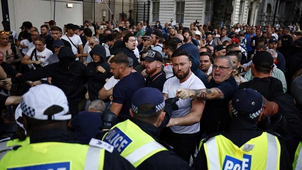 People clash with police outside Downing Street at a demonstration on Wednesday (AFP)