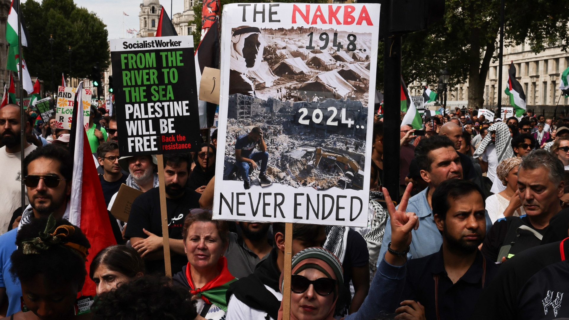 Pro-Palestine protesters hold placards during the "National March for Gaza" demonstration in London on 3 August 2024 (Carlos Jasso/AFP)