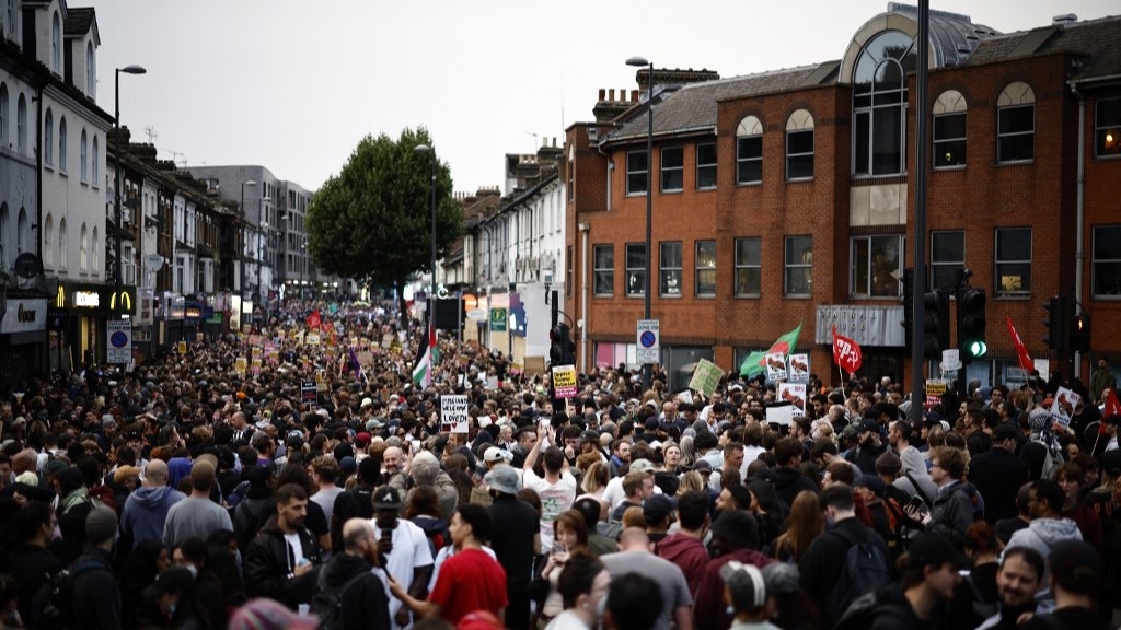 People gather for a counter demonstration against an anti-immigration protest called by far-right activists in the Walthamstow suburb of London on August 7 (Benjamin Cremel, AFP)