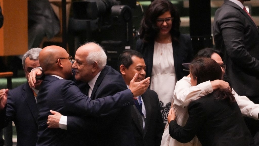 Palestinian representative Ryad Mansour is congratulated on the result of a vote during the emergency session on the legal consequences of Israel's actions in the Palestinian territories at United Nations Headquarters on September 18, 2024 in New York