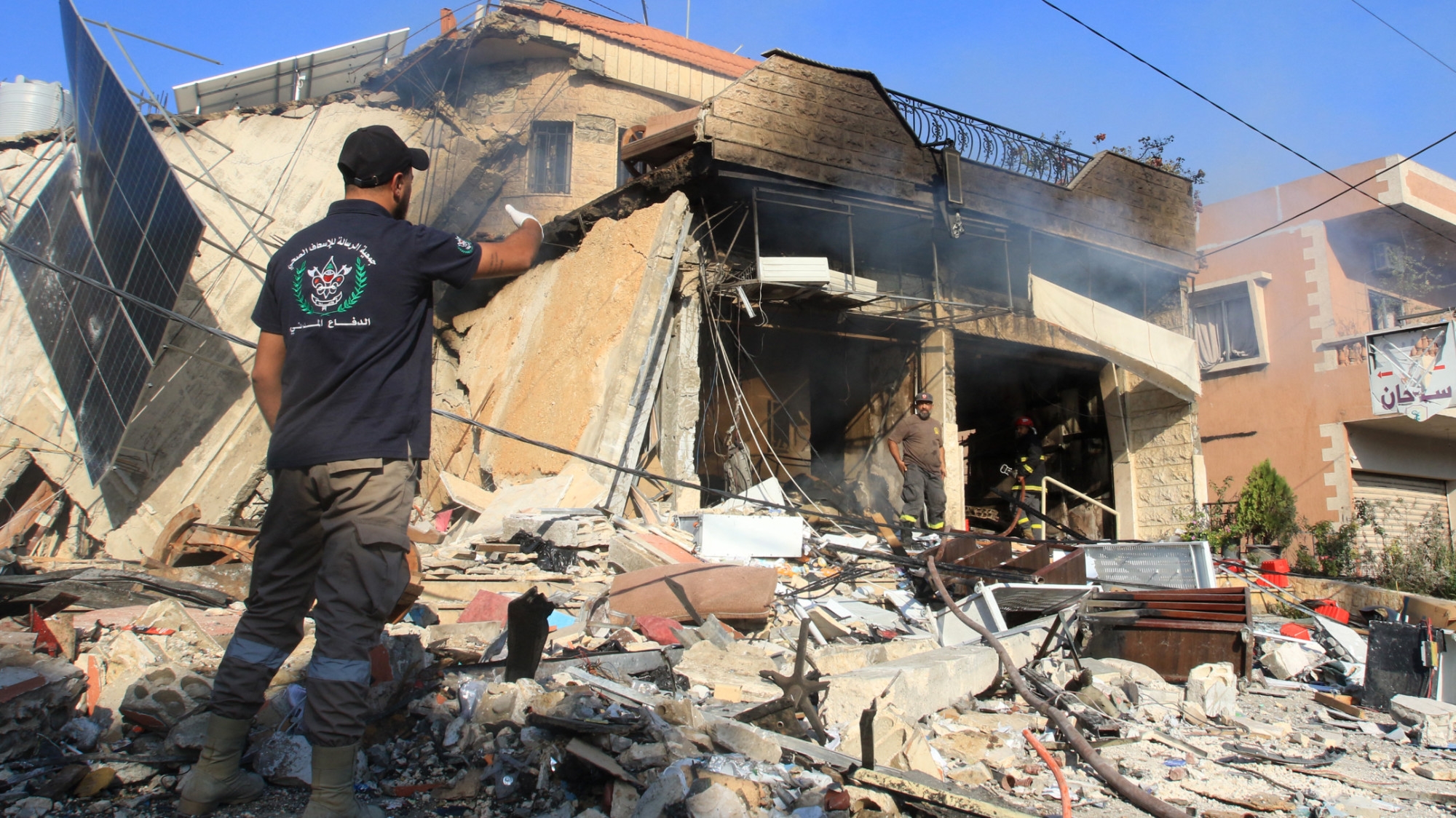 A rescuer inspects the debris at the site of an overnight Israeli strike on a pharmacy in the southern Lebanese village of Akbiyeh on 24 September 2024 (AFP/Mahmoud Zayyat)