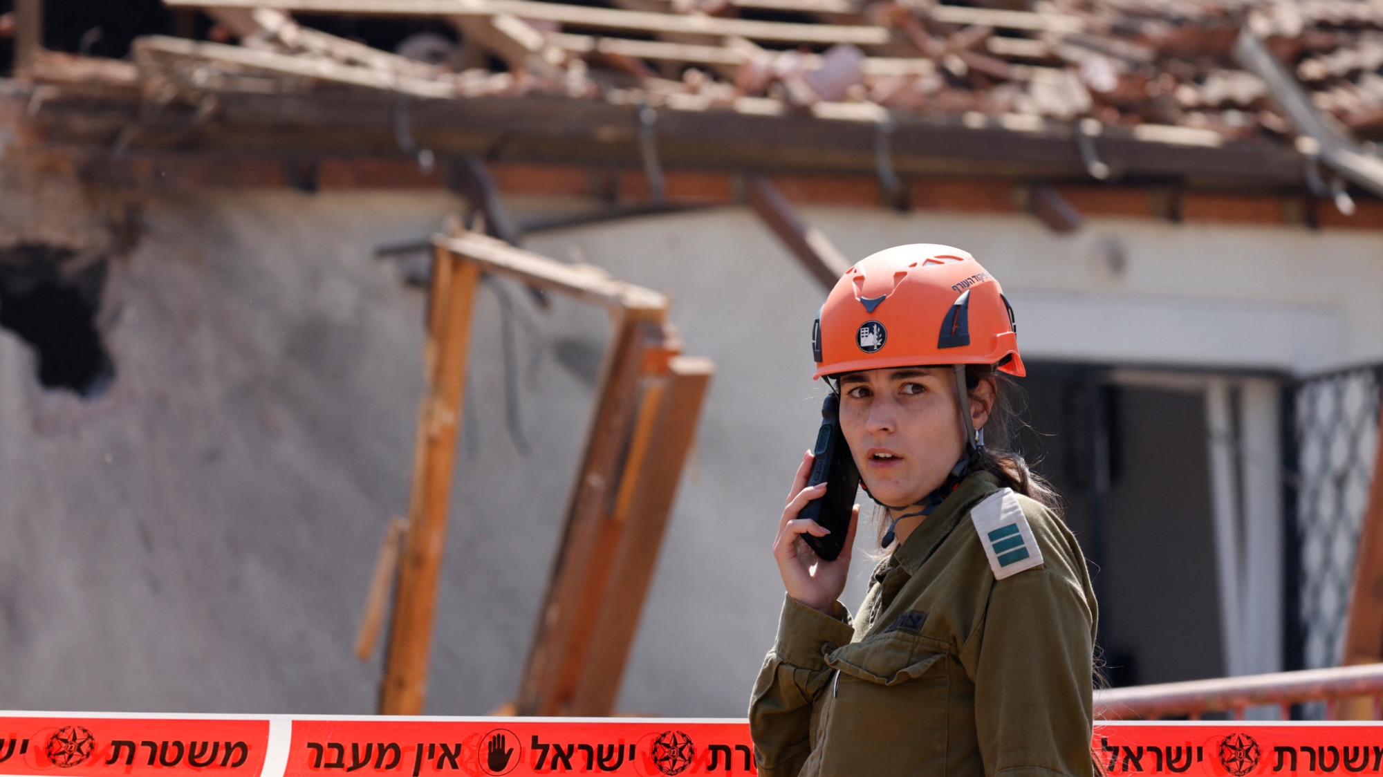 An Israeli emergency responder arrives at the site of a rocket strike, fired from Lebanon, in the northern Israeli city of Safed on 25 September 2024 (AFP/Jalaa Marey)