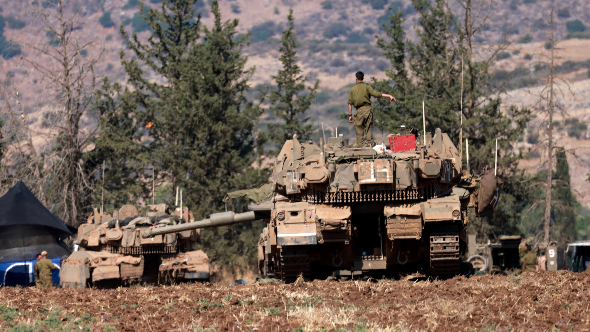 Israeli tanks are deployed in the Upper Galilee region near the border with Lebanon on 29 September 2024 (Menahem Kahana/AFP)