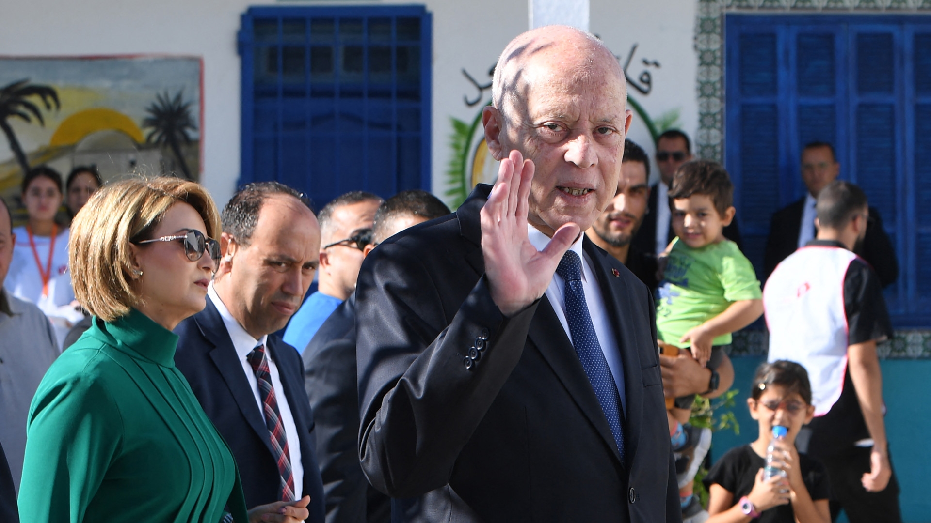 Tunisia's President Kais Saied waves to the crowd outside a polling station in Tunis after casting his vote in the country's presidential election on 6 October (Fethi Belaid/AFP)