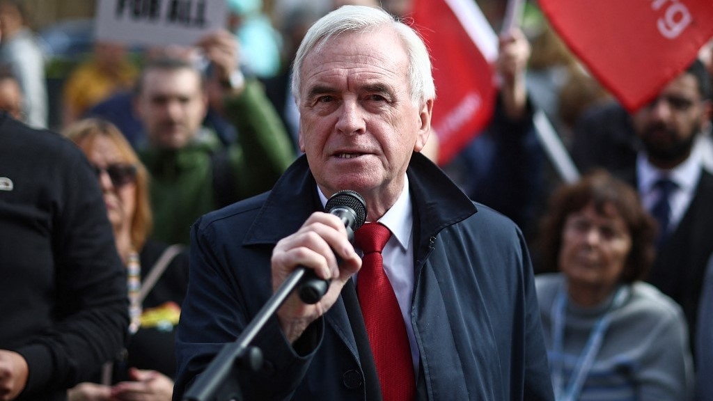 Independent MP John McDonnell speaks as people gather with placards outside parliament to protest against the cut in winter fuel allowance, in central London on 7 October