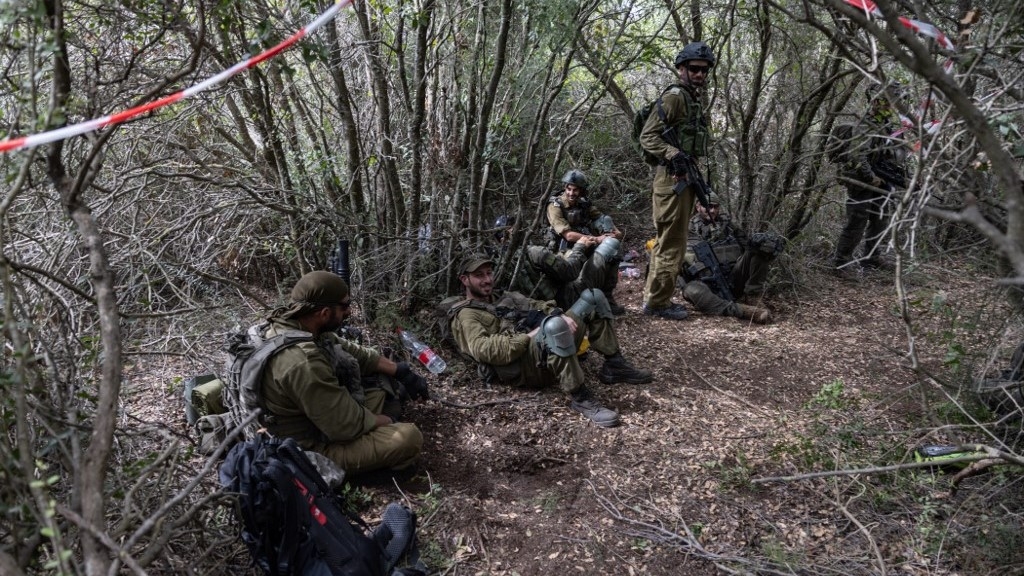  Israeli soldiers resting near what they said is an abandoned Hezbollah position (AFP)