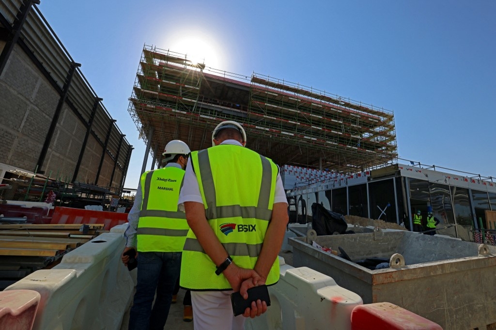 Construction workers on the site of the French Expo 2022 pavilion building in Dubai 