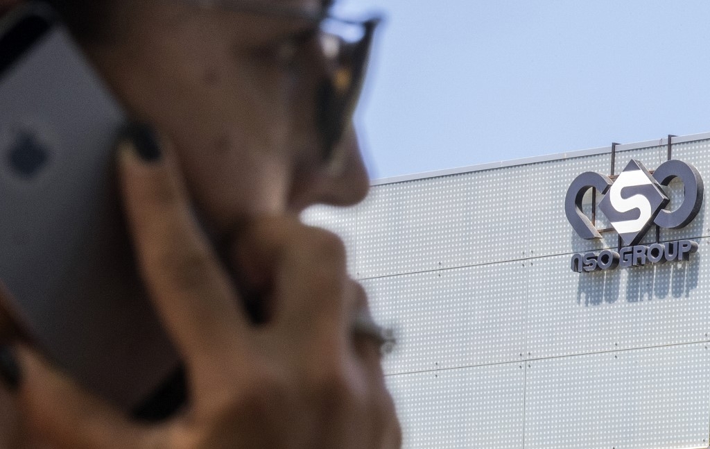 Une Israélienne se sert de son iPhone en face du bâtiment abritant la firme israélienne NSO Group, le 28 août 2016 à Herzliya, dans le district de Tel Aviv (AFP)