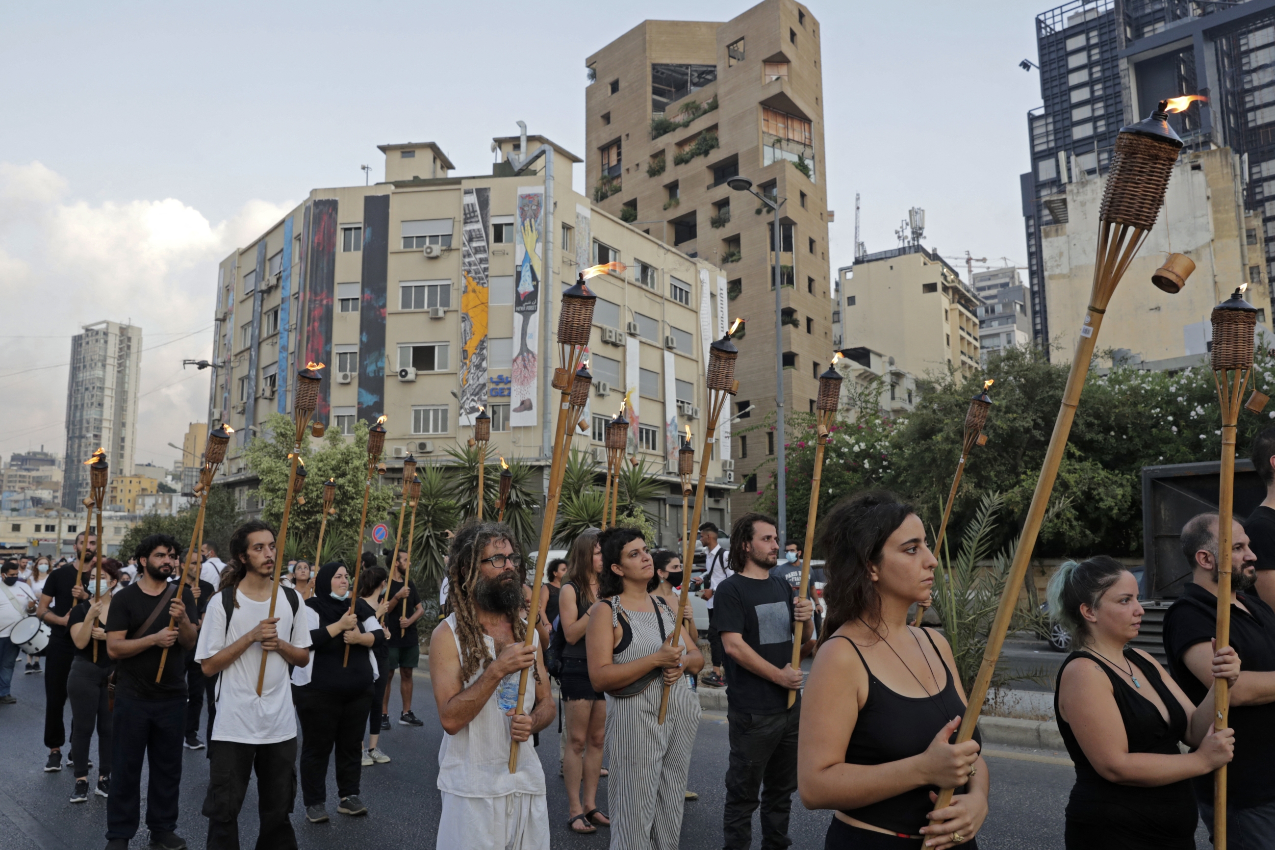 Protesters march with burning torches in Beirut