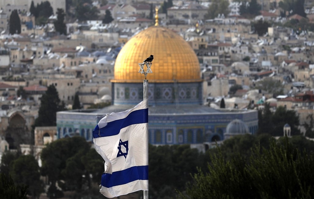 A picture of the Israeli flag with al-Aqsa Mosque seen in the background taken in occupied East Jerusalem on 1 November 2021 (AFP)