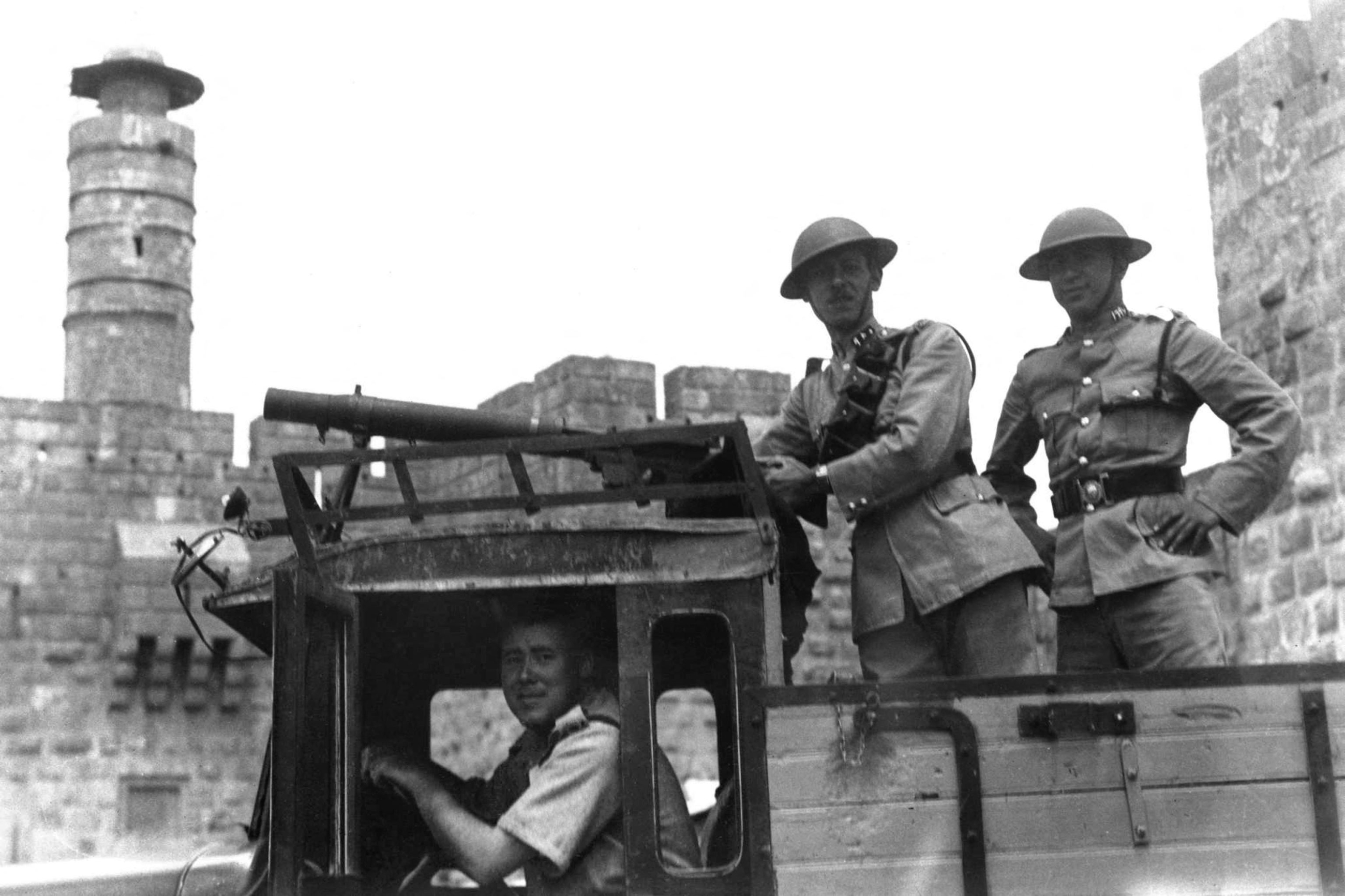 A picture released 10 June 1936 shows armed British soldiers aboard a British military vehicule with a Lewis machine-gun as it passes the citadel in Jerusalem during the British Mandate in Palestine (AFP)
