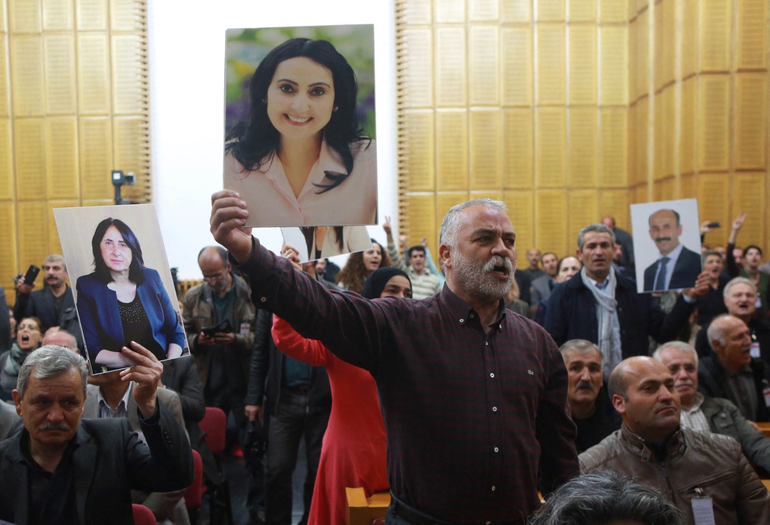 A supporter holds a portrait of Figen Yuksekdag, detained co-leader of Turkey's pro-Kurdish opposition Peoples' Democratic Party (HDP) at a meeting at the Turkish parliament in Ankara, on November 8, 2016 (AFP)