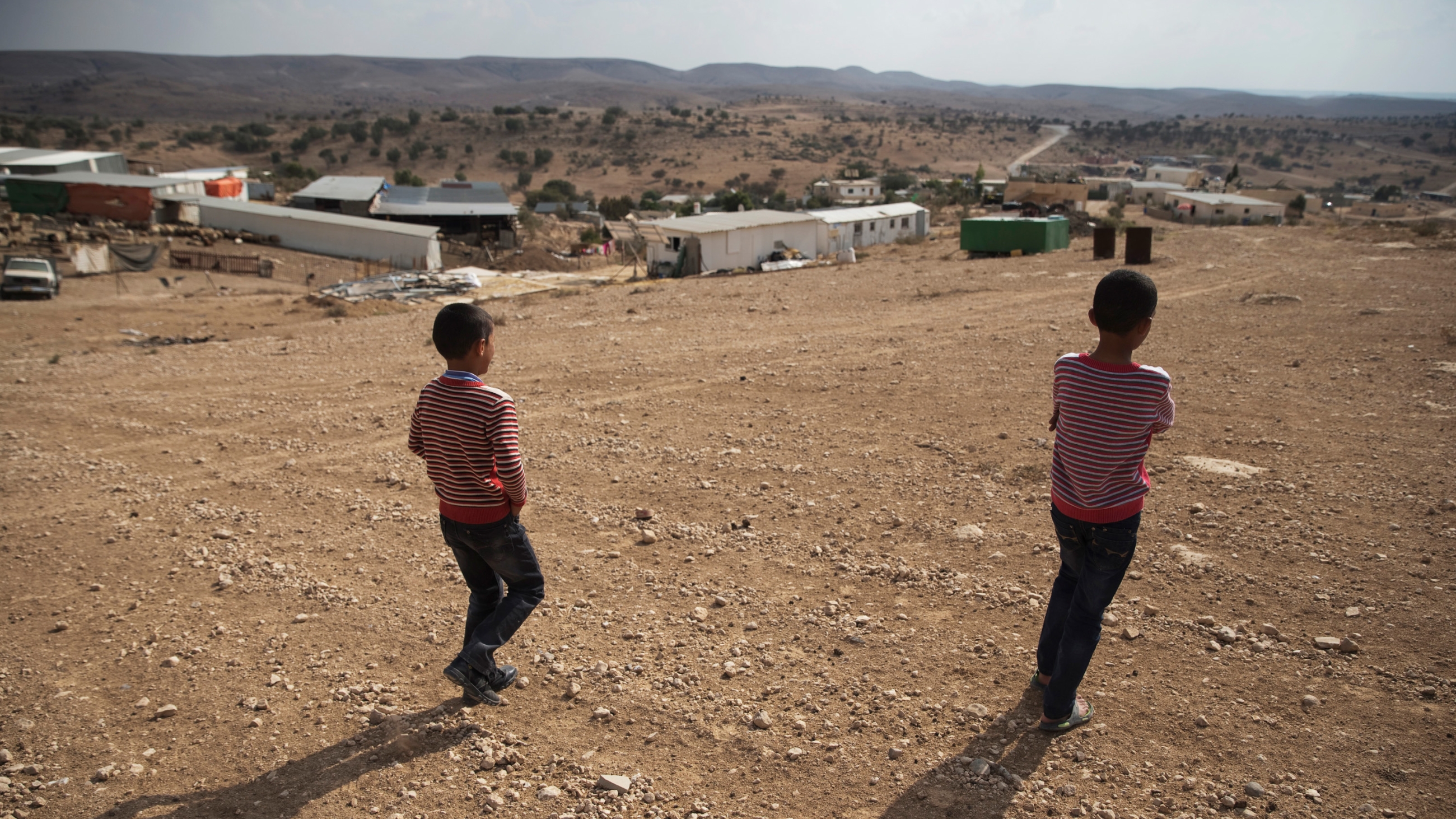 Palestinian boys walk toward the "unrecognised" village of Um Al-Hiram in southern Israel's Negev desert (Reuters)